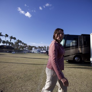 Woman Strolling Through Coachella Festival Grounds at Dusk