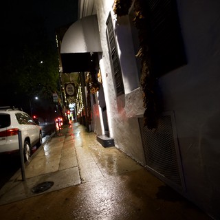 Wet City Street at Night with Holiday Lights