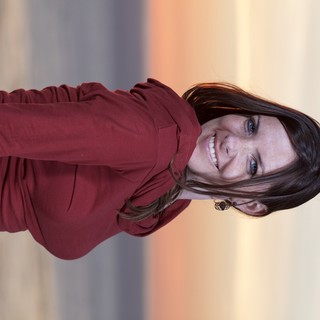 Smiling Woman at Golden Hour Coastal Sunset