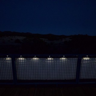 Illuminated Industrial Facility at Twilight in Desert Mountains