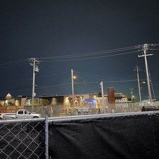 Industrial Night Scene with Power Lines and Graffiti