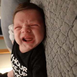 Joyful Baby Laughing on Textured Blanket
