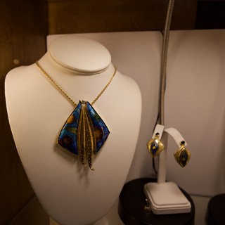 Artisan Jewelry Display with Blue and Gold Pendant