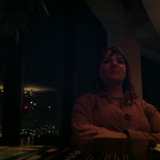 Contemplative Woman at Dimly Lit Urban Restaurant