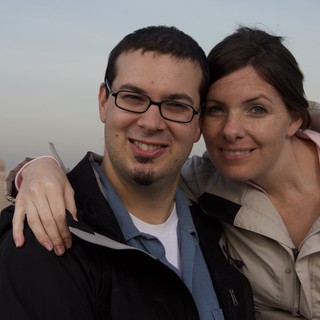 Couple Smiling Together Against City Skyline