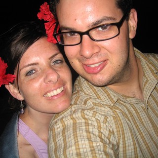 Happy Couple with Red Flowers at Evening Event