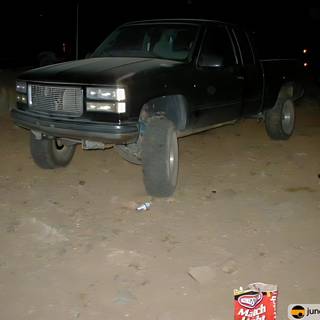 Black Pickup Truck parked in the Desert at Night