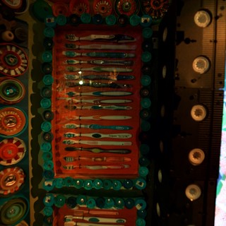 Colorful Folk Art Display with Toothbrushes and Buttons