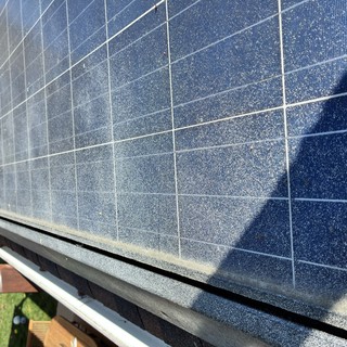 Dusty Solar Panels on Residential Rooftop Installation