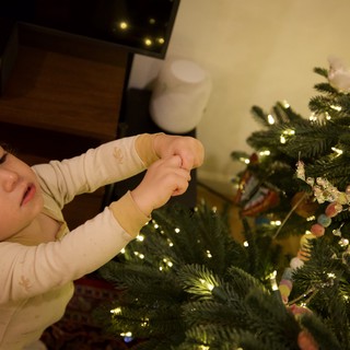 Toddler Decorating Christmas Tree with Ornaments