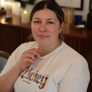 Woman in Colorful Graphic T-Shirt at Home