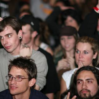 Grey-shirted man among a lively crowd