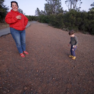 Mother and Child Laughing on Dusty Trail Path