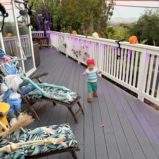 Toddler Exploring Decorated Deck at Outdoor Birthday Party