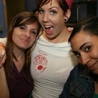 Three Friends Pose Together at a Party