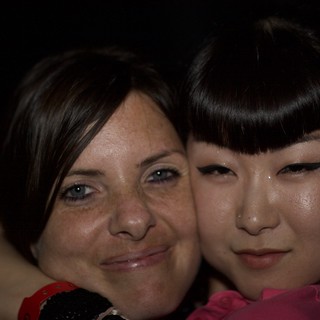 Two Women Share a Close Moment at Night Event