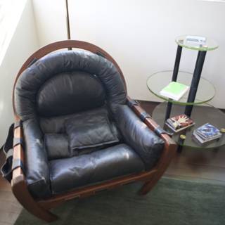 Sleek leather armchair with green cushion