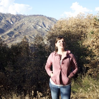 Joyful Woman Smiling in Mountain Wilderness Setting