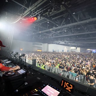 DJ Performs for Massive Indoor Festival Crowd at Midnight