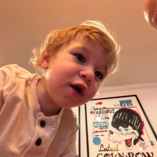 Toddler's Excited Expression Over Colorful Comic Book