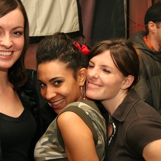 Three Friends Posing Together at a Party