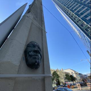 Man's Face Statue on Urban Building