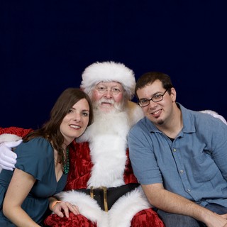 Couple Poses with Santa at Christmas Party