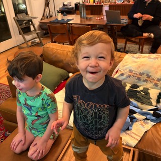 Joyful Toddler Standing on Coffee Table at Home