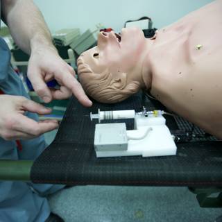 Man operating medical dummy in USC medical center