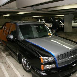 Black and Blue Chevy Truck in a Parking Garage