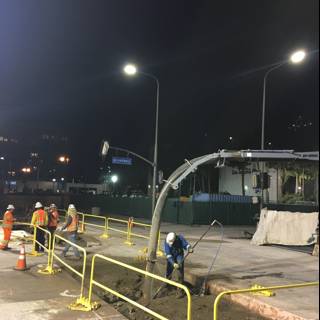 Construction Workers Building the Streets of LA at Night