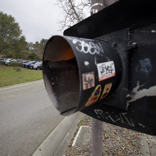 Graffiti-Tagged Black Mailbox in Suburban Setting