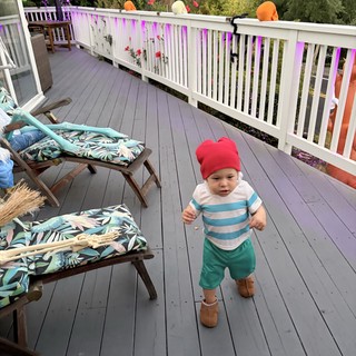 Toddler Exploring Decorated Deck During Outdoor Party