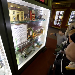 Family Exploring Model Train Display at Museum