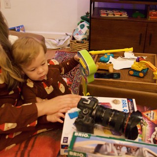 Child Opening Christmas Present with Camera