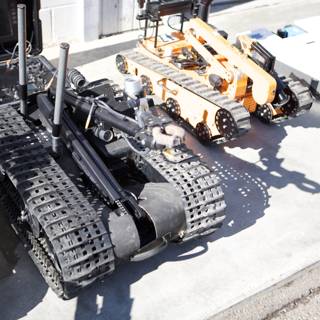 Machine Robot Among Military Equipment