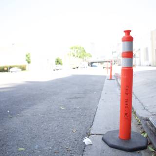 Red and White Traffic Cone on the City Street