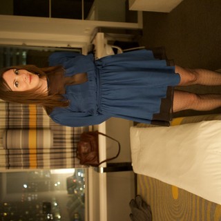 Woman in Blue Dress Poses in Hotel Room