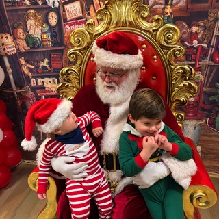 Two Children Visit Santa Claus in His Workshop