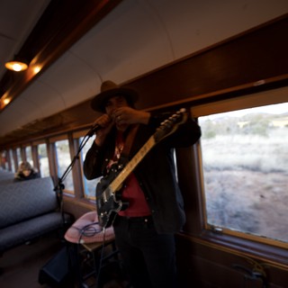 Train Musician Performing During Scenic Desert Journey