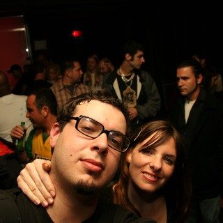 Friends Posing Together at a Crowded Nightclub