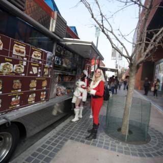 Santa Claus serves burgers from a food truck