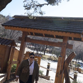 Visitor at Traditional Japanese-Style Garden Gate