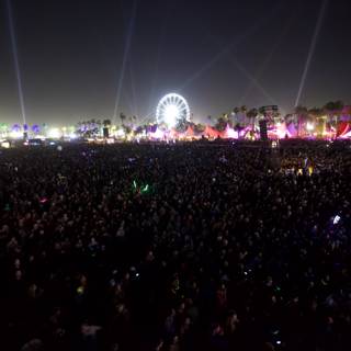 Nighttime Crowd at Coachella with Ferris Wheel in the Background