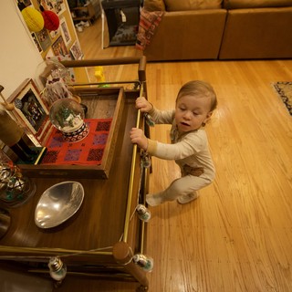 Toddler Exploring Holiday Decorations in Living Room Drawer