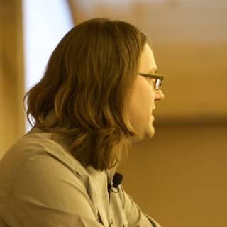 Portrait of a Glasses-Wearing Man with Long Hair at DEFCON 17