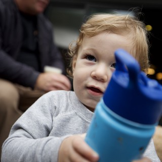 Young Child with Sippy Cup on Family Outing
