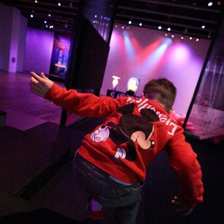 Child Pointing at Stage During Baby Rave Event