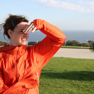 Windswept Woman Shielding Eyes by the Sea