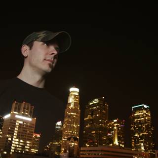 Nighttime cityscape with man in black shirt